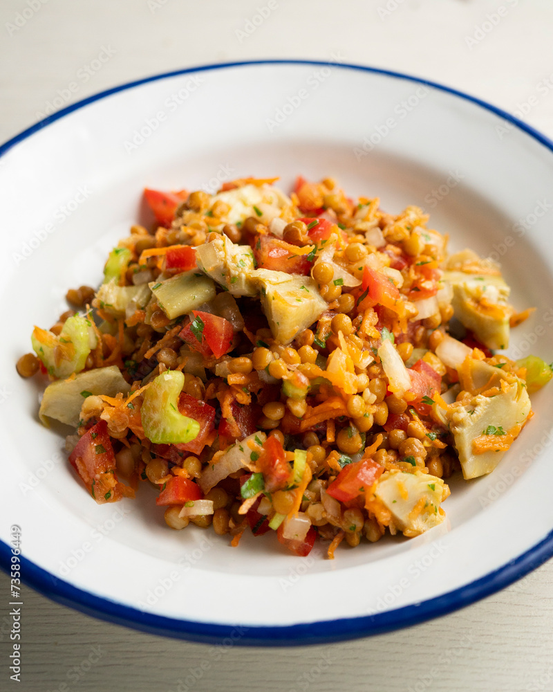 Lentil salad with tomato, onion and artichokes. Lentil salad with tomato, onion and artichokes.