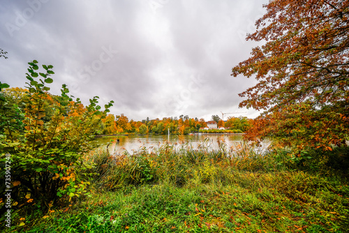 Large pond in Bad Nauheim. Autumnal landscape by the water.
