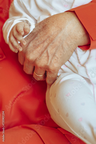 Grandmother Holding Little Child in Her Hands
