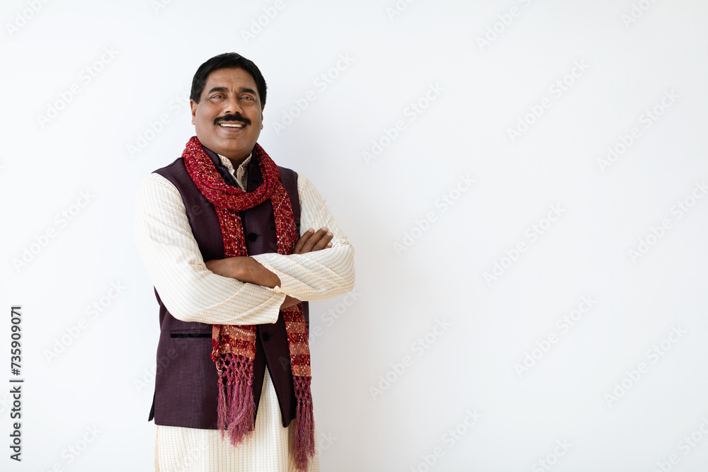 Confident mature indian man in national costume posing on white Confident mature indian man in national costume posing on white