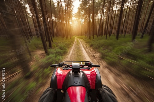 perspectival shot of an atv speeding down a forest path photo