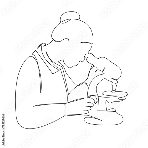 female biologist looking through a microscope
