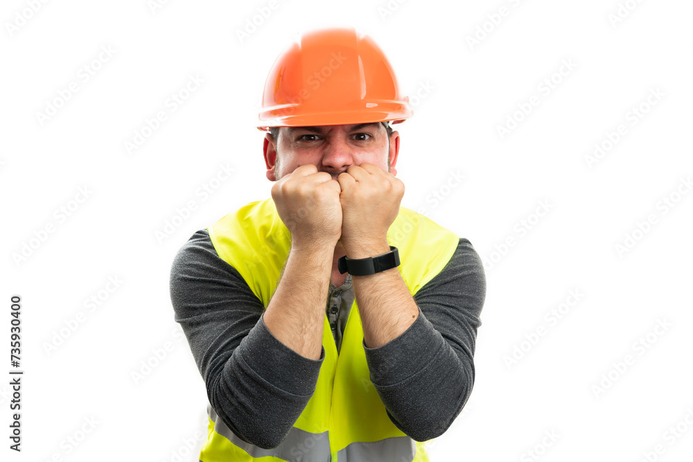Builder male with angry expression using fists to cover mouth Builder male with angry expression using fists to cover mouth
