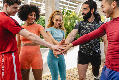 group of friends sports team joining hands