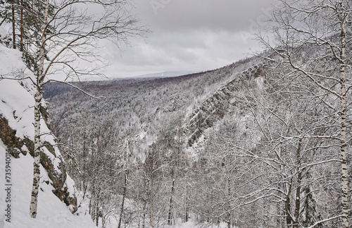 snow coniferous trees in the mountains of the Urals on top of mount aigir. photo