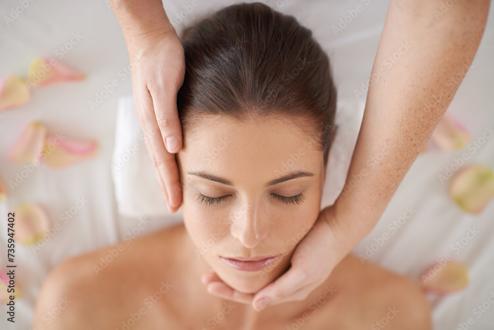 Hands, top view and face massage of woman at spa to relax, peace or calm for aromatherapy with organic flowers. Above, therapy and person at salon for facial treatment, skincare and natural beauty Hands, top view and face massage of woman at spa to relax, peace or calm for aromatherapy with organic flowers. Above, therapy and person at salon for facial treatment, skincare and natural beauty