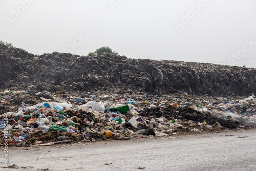 Stacks of household garbage are left on the side of the road. Dumping waste in this way is polluting the environment. photo