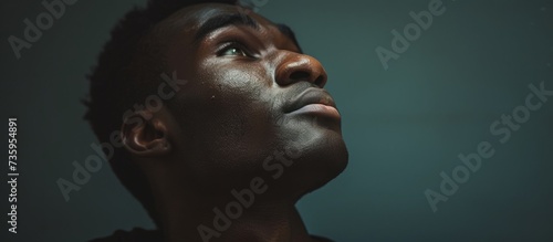 Portrait of an African American man with a black painted face expressing cultural identity and beauty