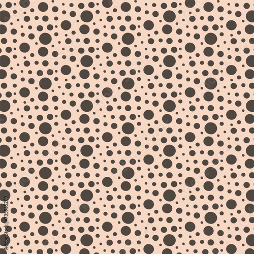 simple texture made from circles of different sizes on a beige background.