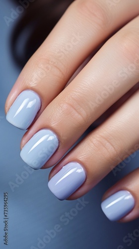 Beautiful and delicate light blue  nude manicure with design  vertical photo