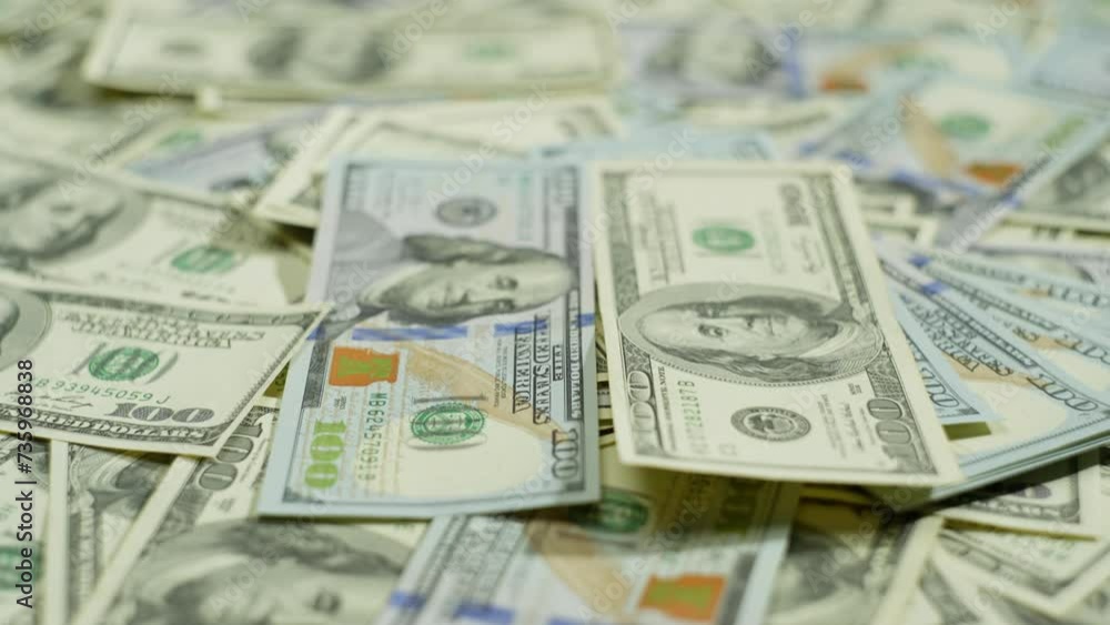 Old and new hundred-dollar bills are spread out on the table. The camera pans over a large amount of cash. High quality 4k footage Old and new hundred-dollar bills are spread out on the table. The camera pans over a large amount of cash. High quality 4k footage