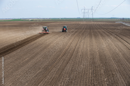 Two tractors are working in the field