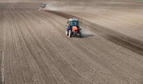 Two tractors are working in the field