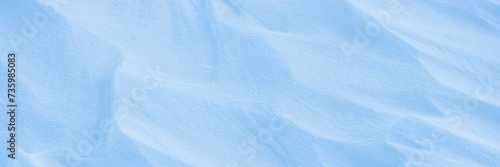 Snow texture. Wind sculpted patterns on snow surface. Wind in the tundra and in the mountains on the surface of the snow sculpts patterns and ridges. Arctic, Polar region. Winter panoramic background. © Andrei Stepanov