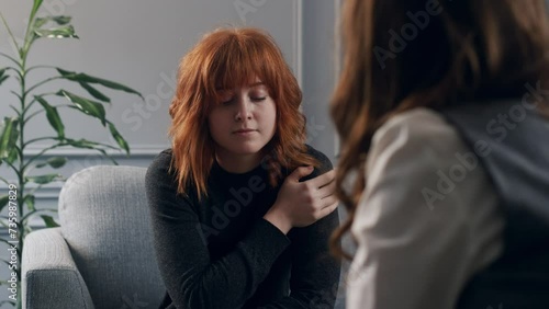 Over shoulder view female psychology giving advice for her young age client who don't know what to do in life. Treatment for girlfriend after abusive relationships. Professional psychotherapeutic help
