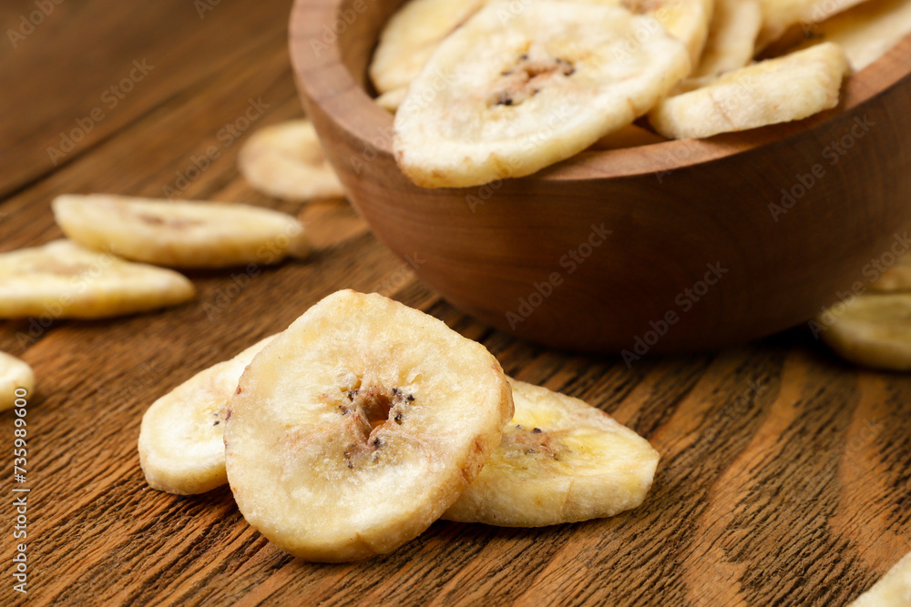 Dried bananas close-up on a wooden table. Dried bananas close-up on a wooden table.