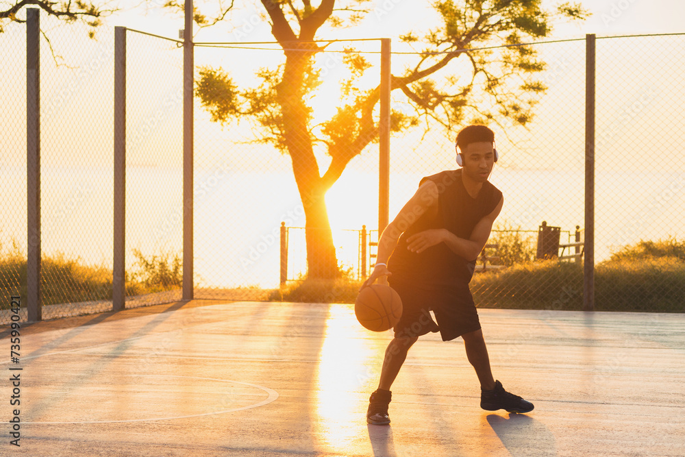 black man doing sports, playing basketball on sunrise, active lifestyle, sunny summer morning black man doing sports, playing basketball on sunrise, active lifestyle, sunny summer morning