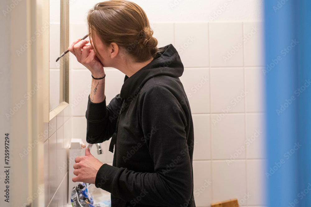 single mum getting ready for work in her bathroom single mum getting ready for work in her bathroom