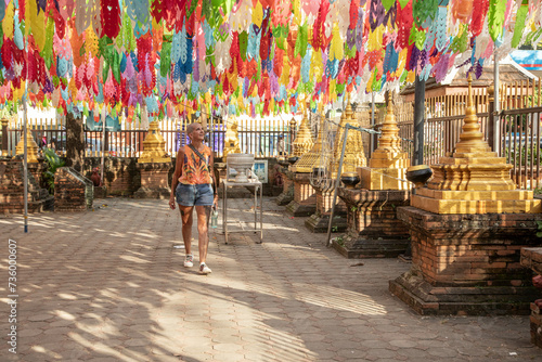 Mid aged woman solo traveller tourist is exploring the Temples in Thailand
