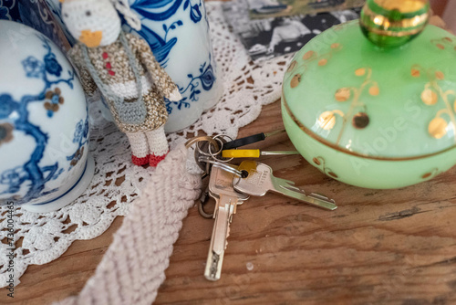 keys left on a beautiful old table with ornaments on the side photo