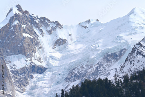 Brown rock peak on the left painted in snow