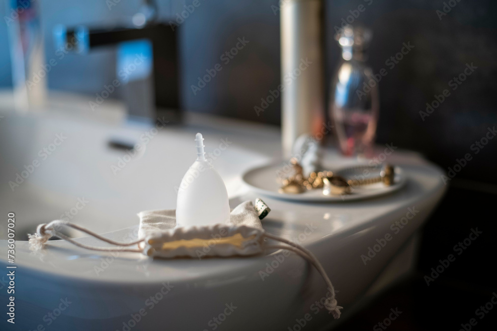 Female sanitary cup on the bathroom sink ready to be used Female sanitary cup on the bathroom sink ready to be used