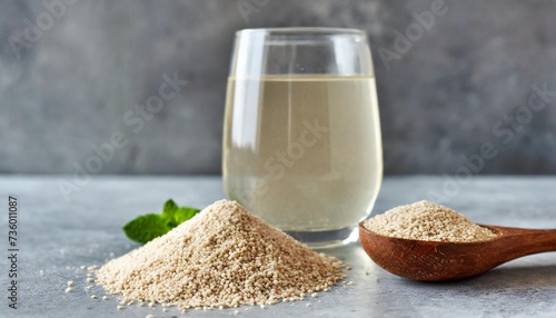 psyllium husk and glass of water soluble fiber supplement for intestinal on grey background superfood for weight loss and low carb diet side view selective focus photo