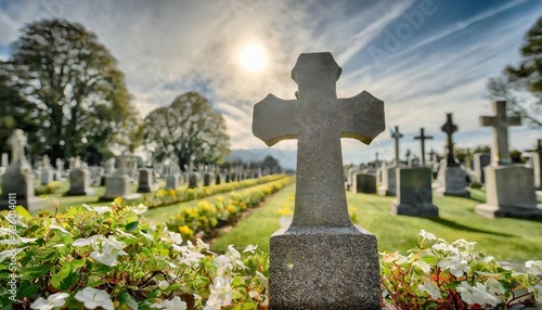capture the solemn beauty of a catholic cemetery with a grave marker and cross engraved on it set against a softly blurred background to create a sense of peaceful serenity funeral concept