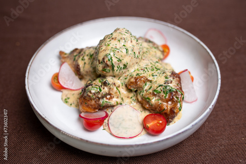 Juicy Chicken Fricassee with Creamy White Sauce and Fresh Vegetables on Plate