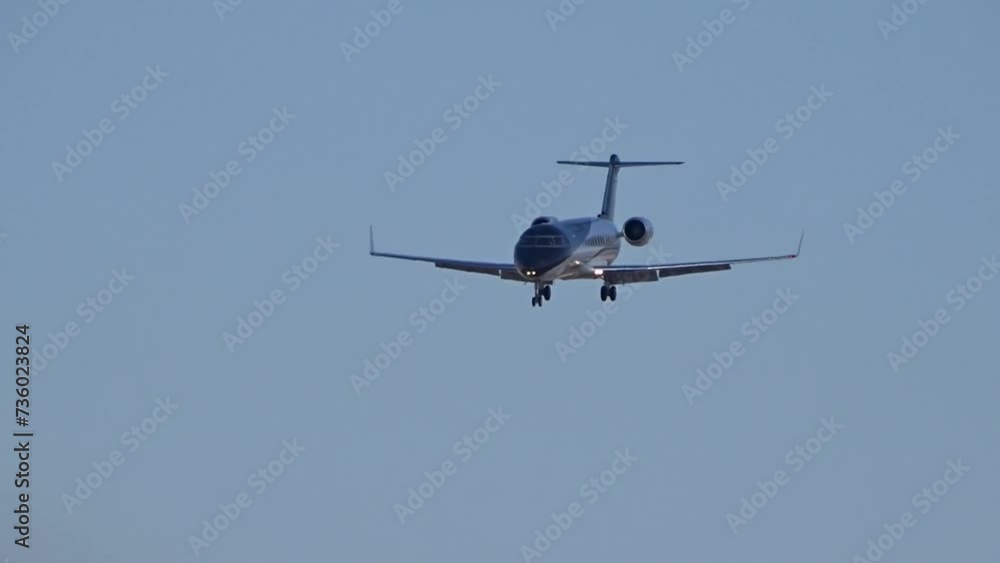 Black corporate jet arriving into international airport blue skies landing Black corporate jet arriving into international airport blue skies landing
