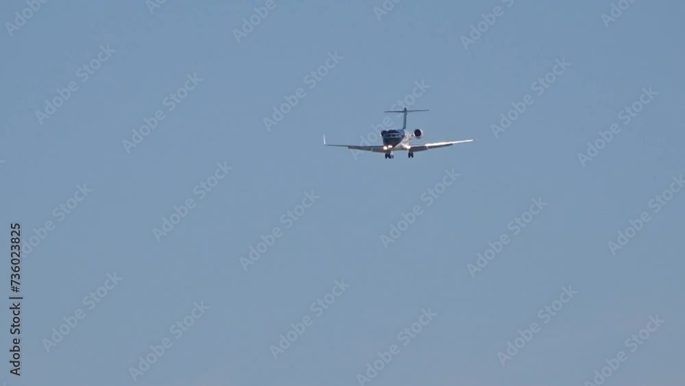 Black business jet flying final approach for landing at airport Black business jet flying final approach for landing at airport