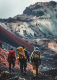 Group of hikers with backpacks walking on the trail to the top of the volcano.
