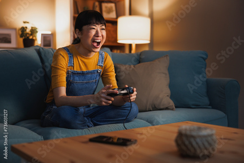 Woman having fun playing video games at home