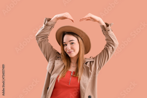 Young woman making heart wi...