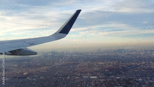 Airplane close up wing view on new york skyline usa smog polluting air taking off take off john f kennedy airport photo