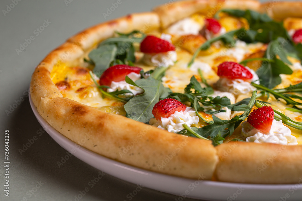 Freshly Baked Pizza with Strawberries, Cream Cheese, and Arugula on White Plate - Summer Party Theme Freshly Baked Pizza with Strawberries, Cream Cheese, and Arugula on White Plate - Summer Party Theme