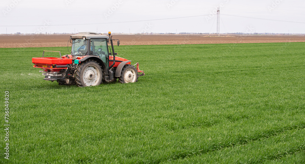 Tractor spreading artificial fertilizers Tractor spreading artificial fertilizers