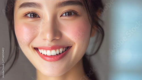 A radiant woman displaying a joyful smile with healthy teeth, showcasing beauty and dental care in a close-up view
