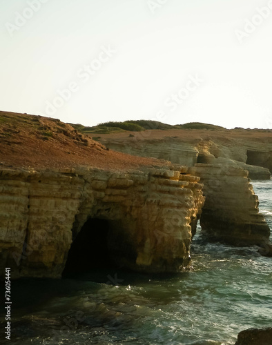 Water caves and rock formations close to Coral Bay on Cyprus Island. photo