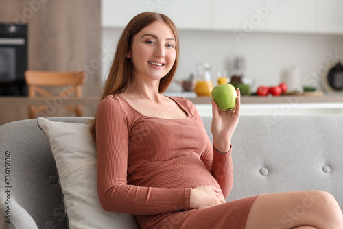 Smiling pregnant woman hold...
