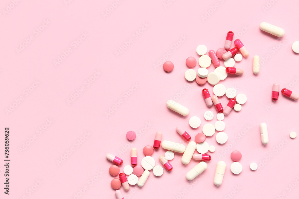 Many different pills on pink background Many different pills on pink background