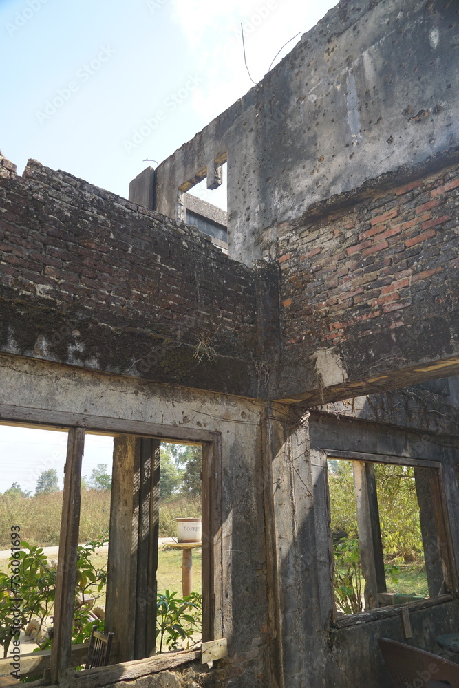 Ruins of an old house with a through passage. Destruction.