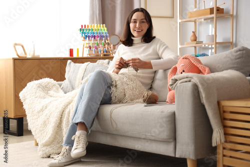 Young woman knitting with n...