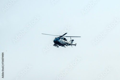 Fototapeta Naklejka Na Ścianę i Meble -  Helicopter flying on isolated blur sky