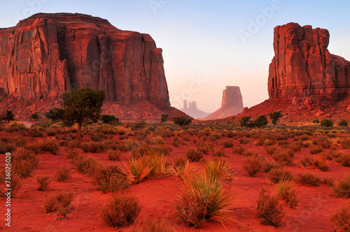 Twilight view of the North Window, between Elephant Butte and Cly Butte, towards East Mitten Butte and other spires and towers of Monument Valley Navajo Tribal Park, Arizona, Southwest USA. photo