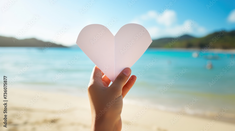 hand hold heart white paper on ocean with copy space hand hold heart white paper on ocean with copy space