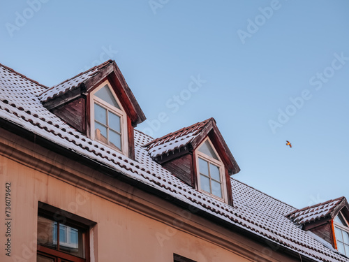 Windows of the attic floor in an old house in the center of Vilnius in winter