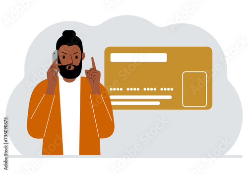 The man is talking on the phone. Nearby is a large plastic card.