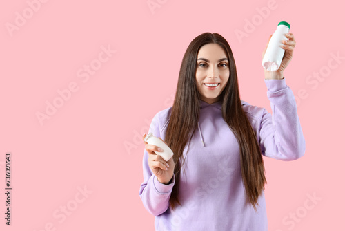 Young woman with bottles of...