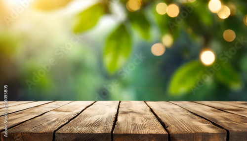 Blank empty wooden table for products with green summer spring plants blurred background